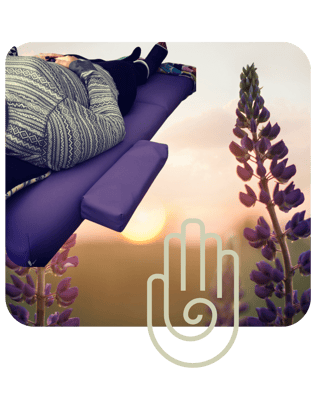 Reiki session in Phoenixville by The Earth Siren, showing a person lying on a purple energy table with a sunset and purple flowers in the background, symbolizing healing and chakra alignment. Reiki session in Phoenixville by The Earth Siren, showing a person lying on a purple energy table with a sunset and purple flowers in the background, symbolizing healing and chakra alignment.