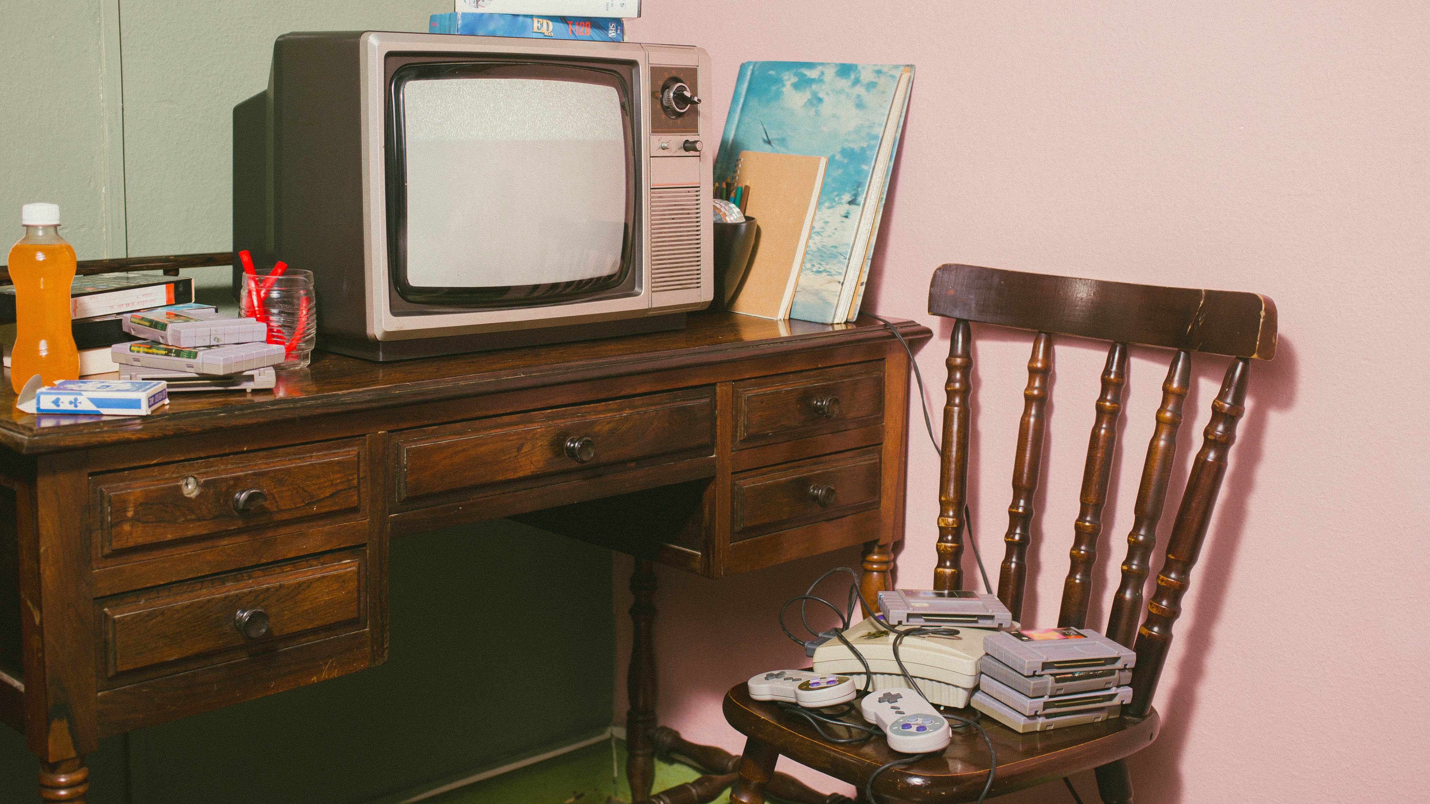 A childhood bedroom with a vintage TV, Super Nintendo controllers, and nostalgic clutter at a 4th house astrology holiday gathering, the room that never fully got updated.