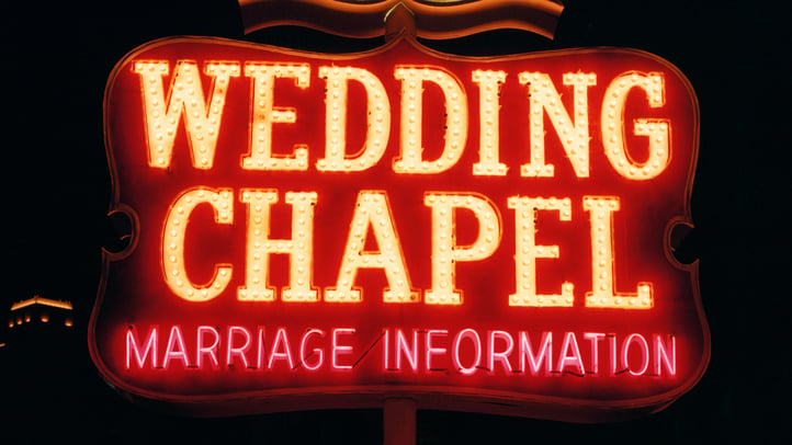 Intimate Las Vegas wedding chapel with warm lighting, fresh flowers, and elegantly dressed guests gathered for a spontaneous 7th house astrology wedding centered around partnership, commitment, and Venusian romance.