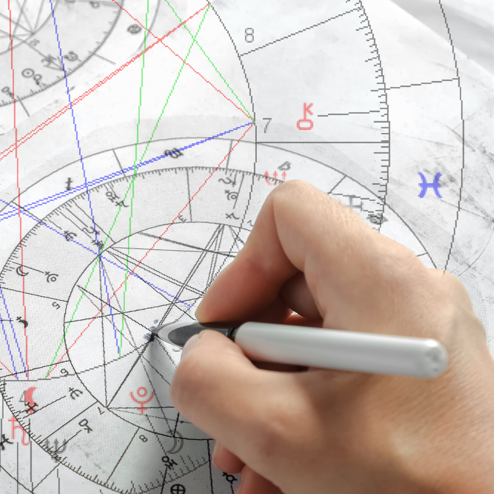 Earth Siren astrology chart being annotated by hand, symbolizing multiple written follow-up questions for continued reflection after a reading.